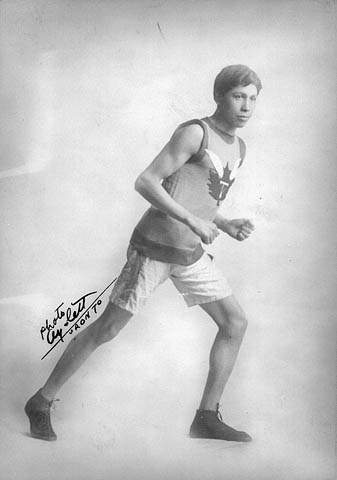 Tom Longboat in a running uniform in an old studio photo