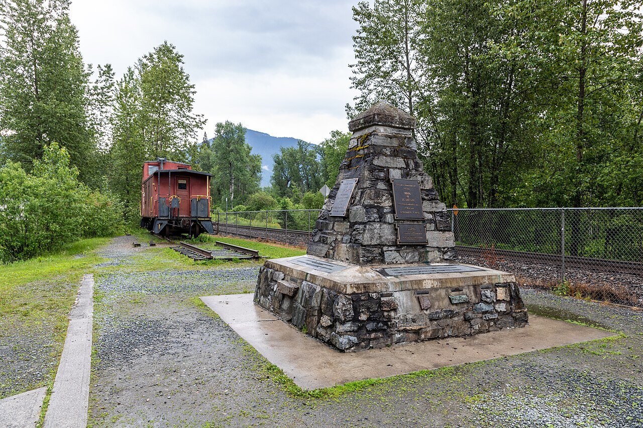 Stone monument beside railway tracks in the mountains